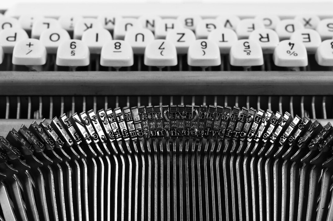 Close-up of vintage typewriter keys with a sheet of paper